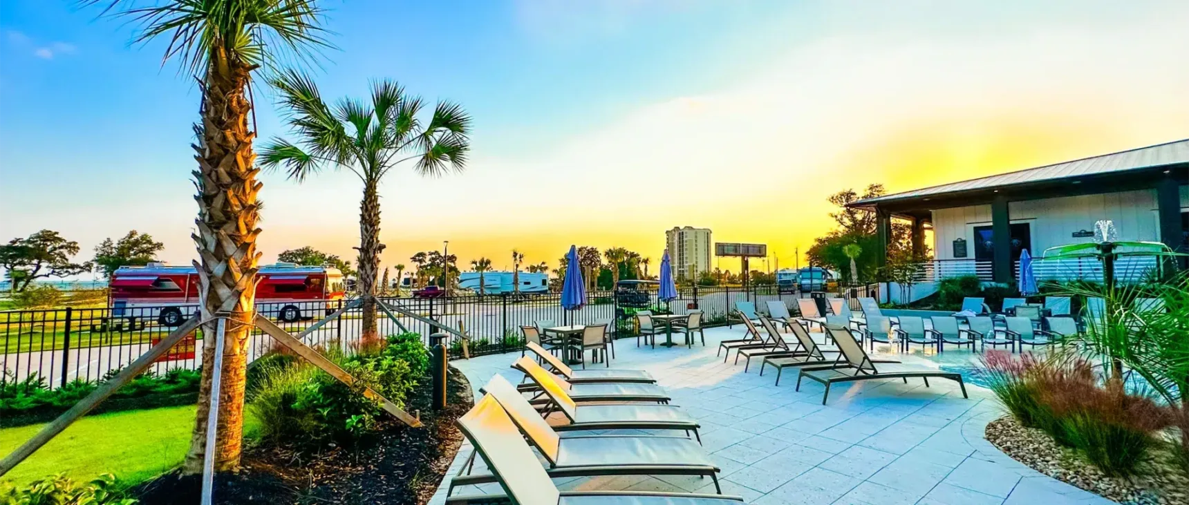 Pool view at dusk with relaxing landscaping.